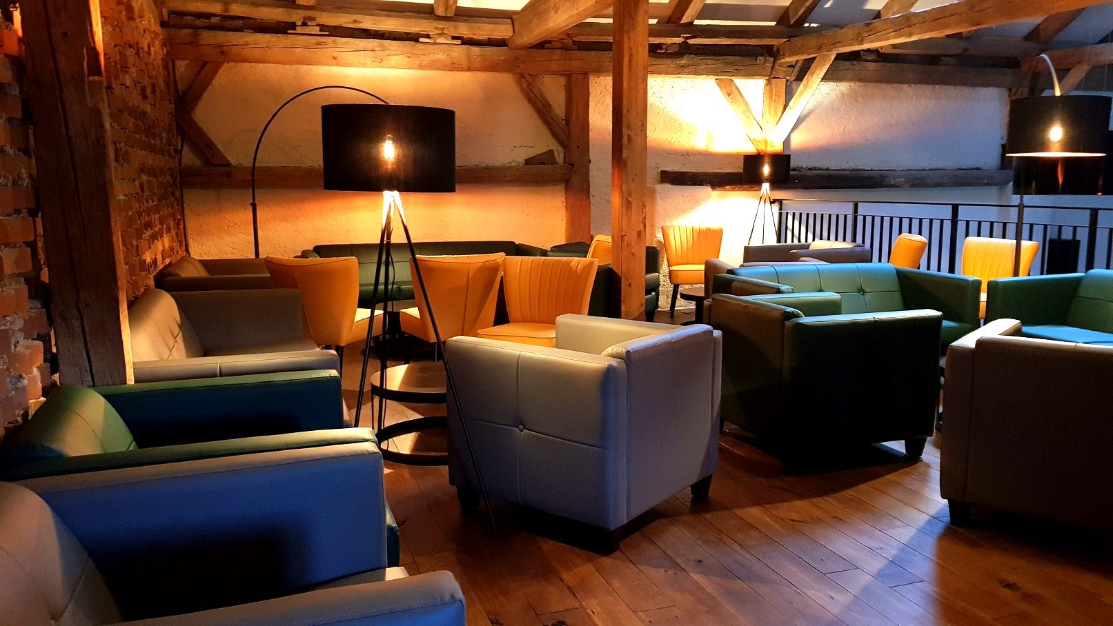Lounge mit Ledersofas unter dem Dachgebälk